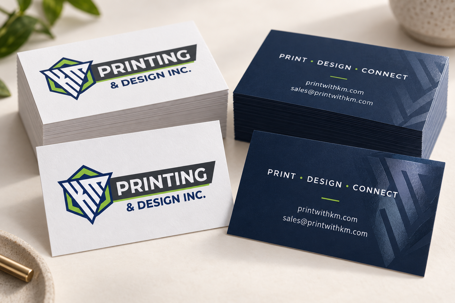 KM branded business cards in navy, lime and white