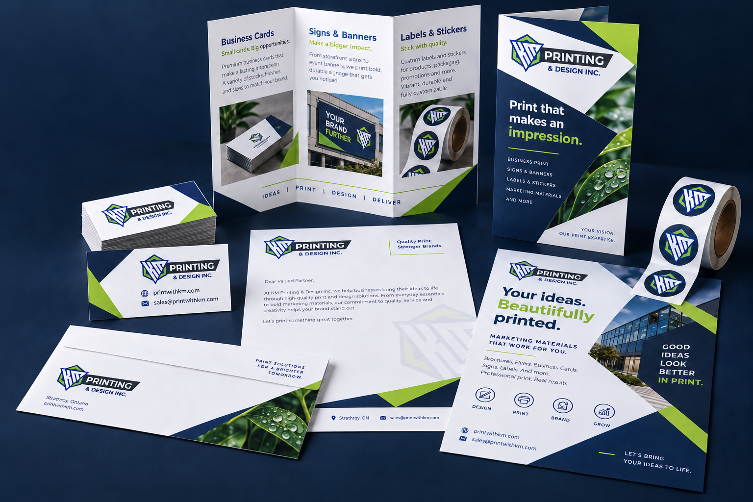 KM-branded print mockup showing finished business cards, brochure, stationery and labels